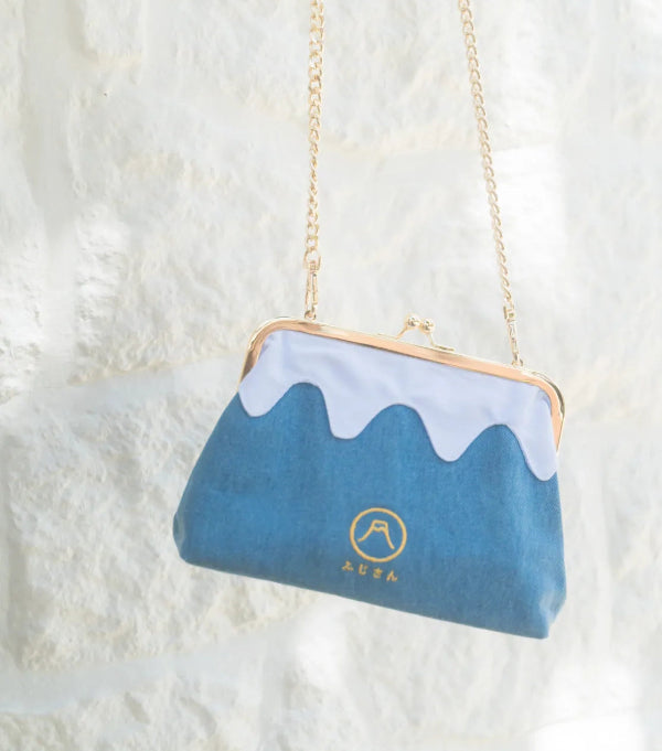 A light denim blue Mt. Fuji Pocket Bag hanging against a white wall at Grandmama Store in Hong Kong.