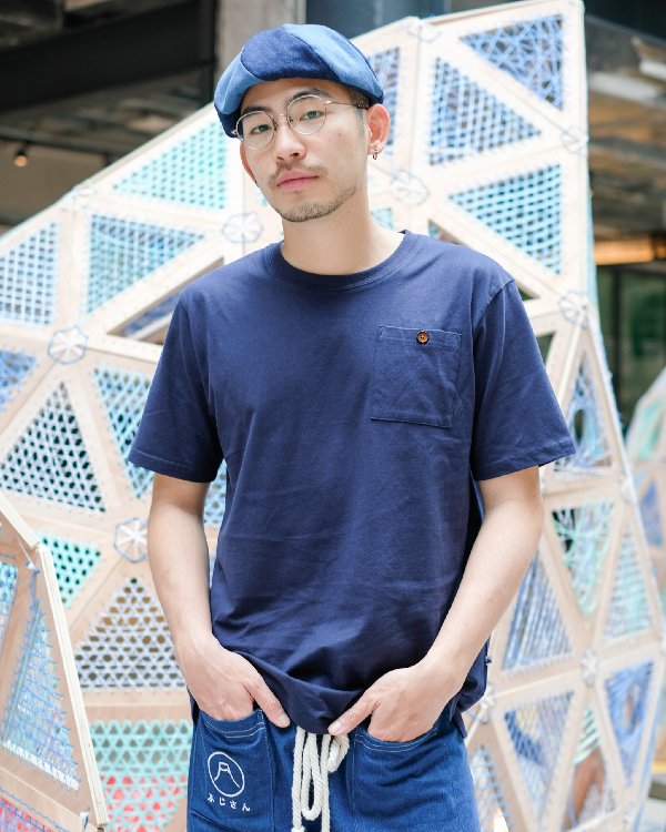A man modeling the Oxford blue Kamon Japanese Waist Rope Pants with Mt. Fuji pocket detail at Grandmama Store in Hong Kong.