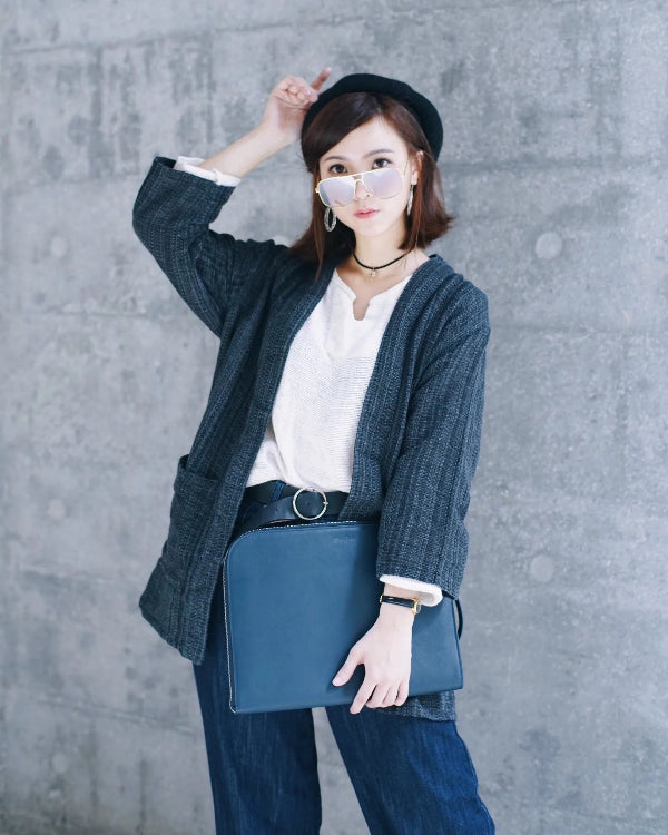 A stylish woman modeling a charcoal grey Hand-cranked Kimono at Grandmama Store in Hong Kong