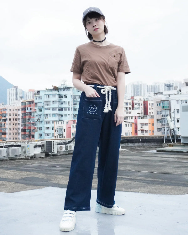A woman modeling dark navy blue Kamon Japanese Waist Rope Pants on a rooftop at Grandmama Store in Hong Kong.