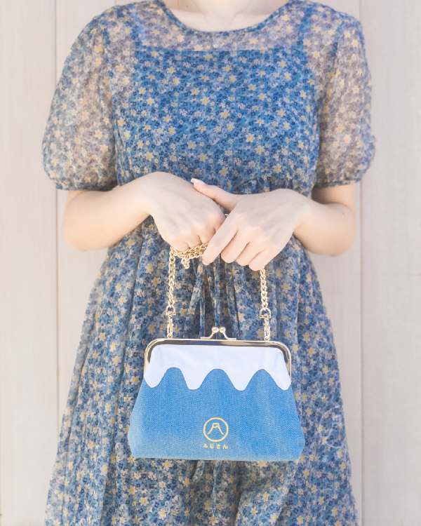 A woman modeling the light blue Mt. Fuji Pocket Bag at Grandmama Store in Hong Kong.