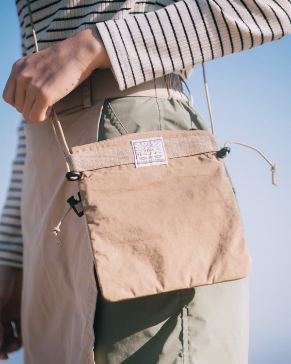 Back view of light brown Yama Multifunctional Bag with brand label at Grandmama Store in Hong Kong.