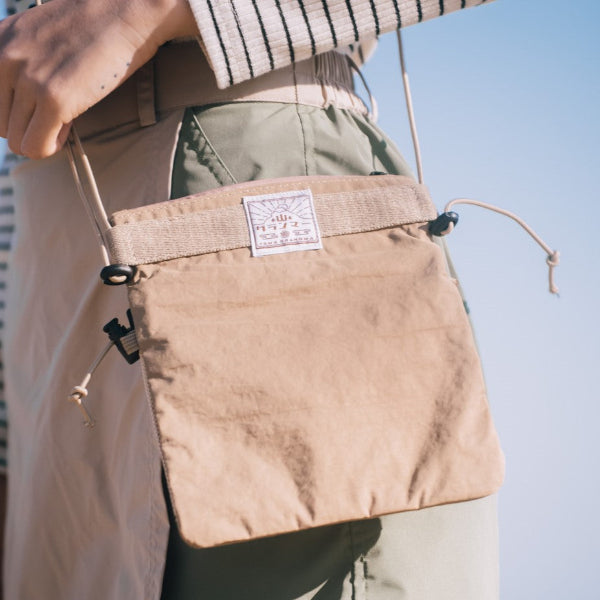 Back view of the brown Yama Multifunctional Bag with brand logo patch at Grandmama Store in Hong Kong.