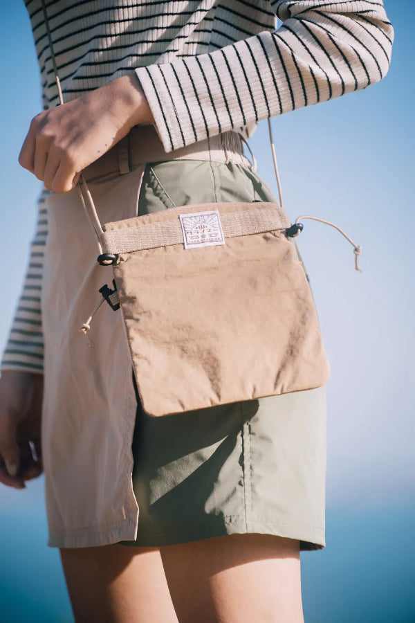 Close-up back view of beige Yama Multifunctional Bag with logo label at Grandmama Store in Hong Kong.