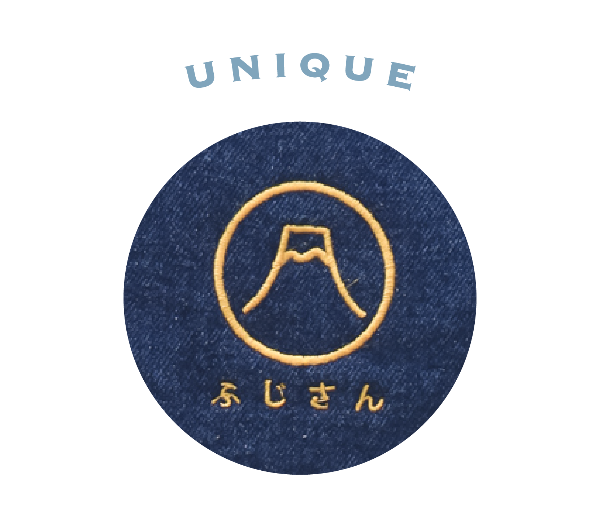 Close-up detail of the gold embroidered Mt. Fuji logo on dark denim for the Mt. Fuji Pocket Bag at Grandmama Store in Hong Kong.