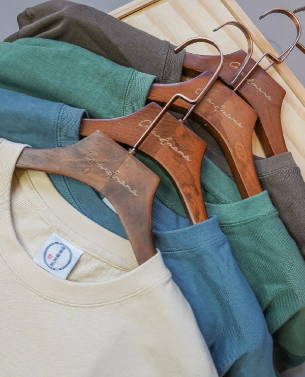 Close-up of Yama Basic Color Tees on wooden hangers at Grandmama Store in Hong Kong.