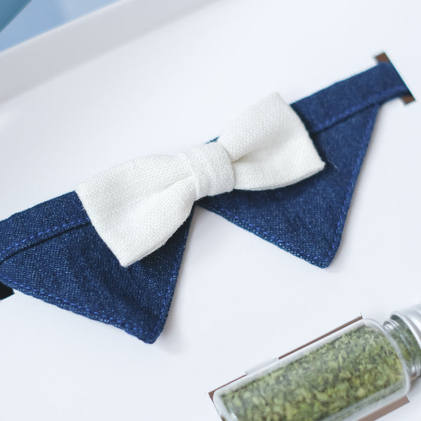 Close-up of a blue denim pet collar with white bow tie at Grandmama Store in Hong Kong.