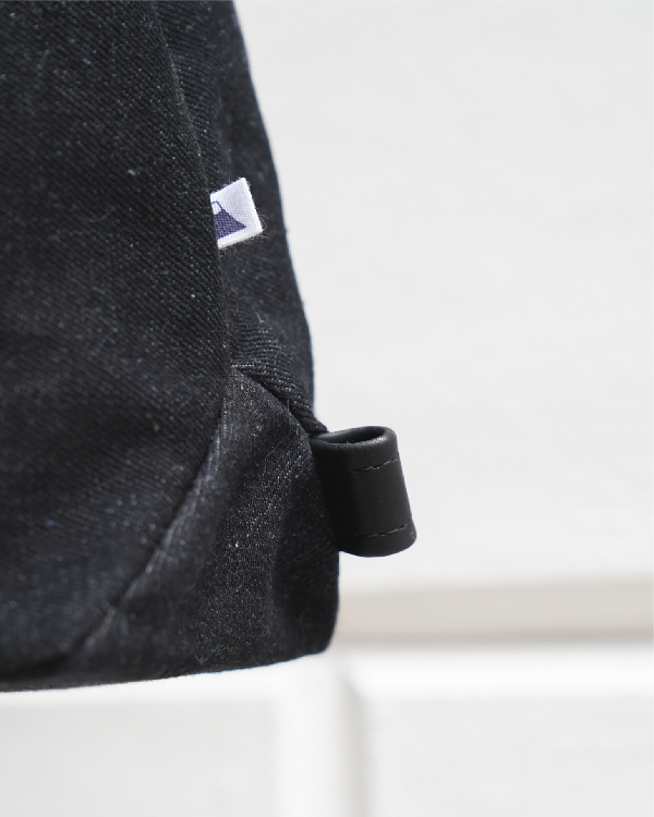 Close-up of fine sewing lines and needlework detail on the Light of Dawn Sake Bag in Black Denim at Grandmama Store in Hong Kong.