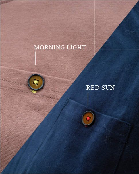 Close-up of pocket button stitching details on the Kamon Tee in Morning Light brown and Red Sun navy blue colorways at Grandmama Store in Hong Kong.