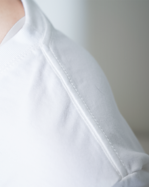 Close-up of shoulder seam craftsmanship on the Dancing Cat Tee at Grandmama Store in Hong Kong.
