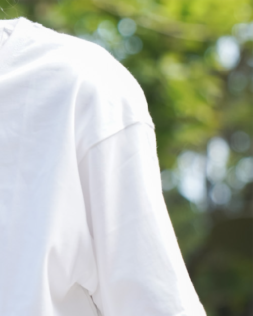 Close-up of sleeve stitching on the white Dancing Cat Tee at Grandmama Store in Hong Kong.