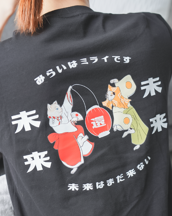 Close-up of the back graphic print on the black Dancing Cat Tee at Grandmama Store in Hong Kong.