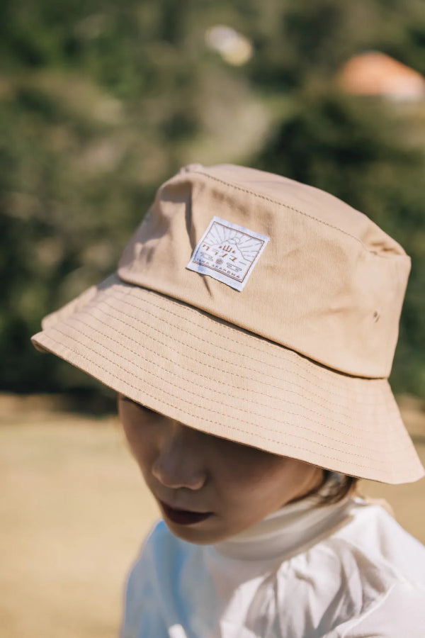Close-up of the beige Yama Workwear Bucket Hat with logo patch at Grandmama Store in Hong Kong.