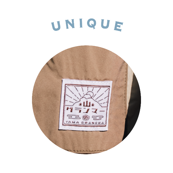 Close-up of the woven brand logo patch on the Morikawa Yama Kimono Jacket at Grandmama Store in Hong Kong.