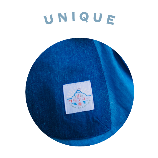 Close-up of the woven brand logo patch on the blue pocket of the Yama Ocean Pocket Dress at Grandmama Store in Hong Kong.