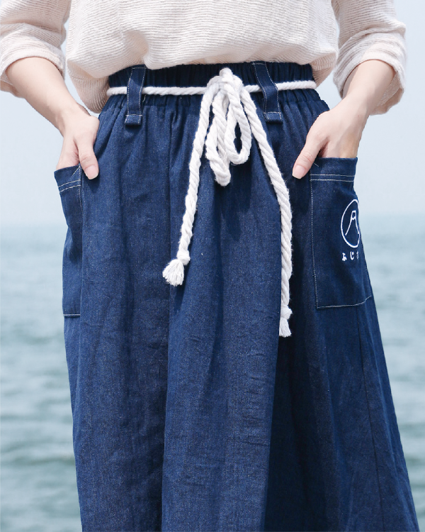 Close-up view of the navy blue Kamon Denim Dress waistline and braided rope belt at Grandmama Store in Hong Kong.