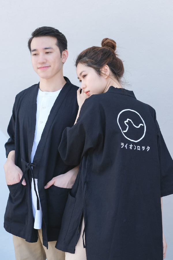 Couple wearing navy blue Kamon Kimono Jackets with Lion Rock embroidery at Grandmama Store in Hong Kong.