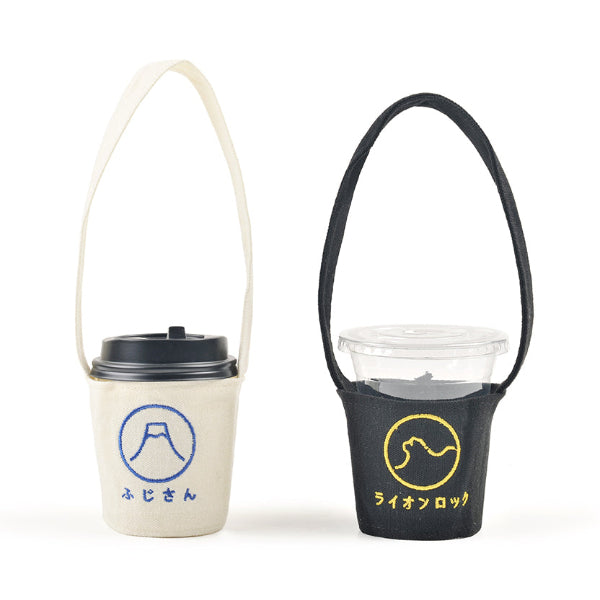 Cream Mt. Fuji and black Lion Rock Kamon Cup Sleeves shown side by side at Grandmama Store in Hong Kong.