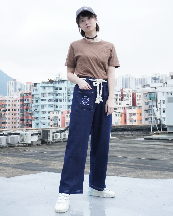 Female model wearing navy blue Kamon Japanese Waist Rope Pants with Lion Rock patch on a rooftop at Grandmama Store in Hong Kong.