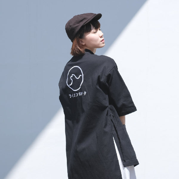 Female model wearing navy blue Kamon Kimono Jacket in an outdoor setting at Grandmama Store in Hong Kong.
