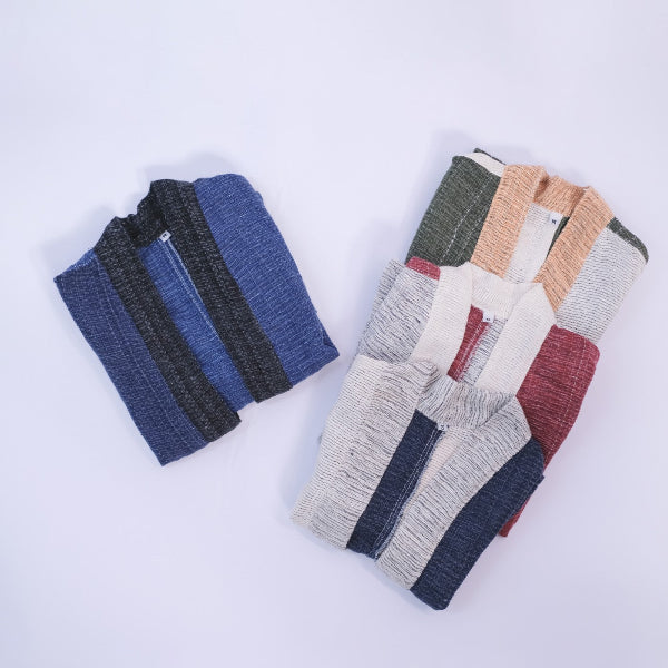 Flat lay view of four folded Hand-cranked Kids Kimono jackets in various woven colorways at Grandmama Store in Hong Kong.