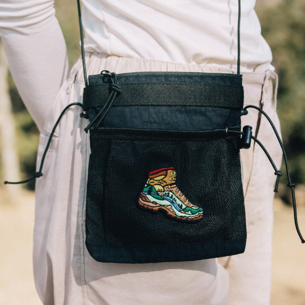 Front view of the Yama Multifunctional Bag｜Black with hiking boot patch worn cross-body at Grandmama Store in Hong Kong.