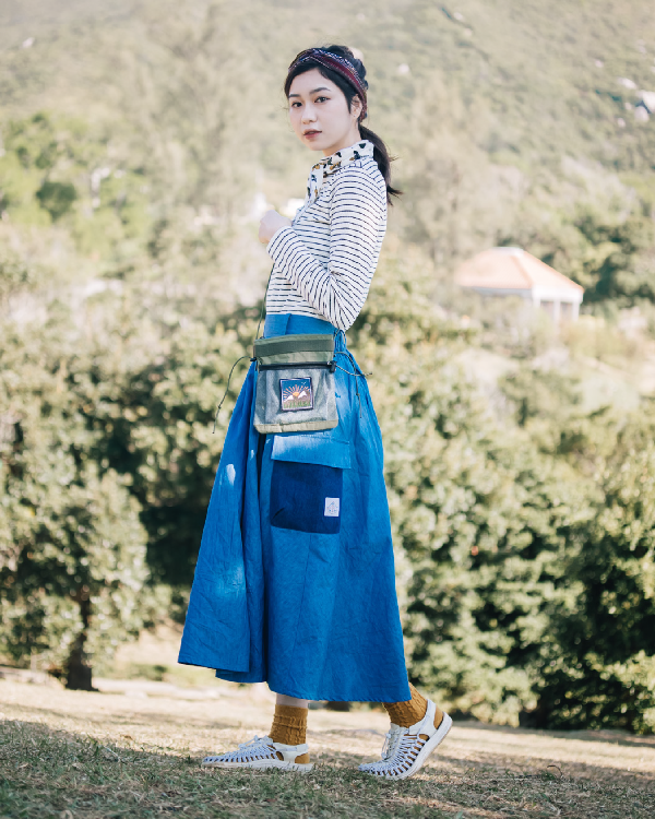 Full-length side profile shot of the light blue Yama Ocean Pocket Dress outdoors at Grandmama Store in Hong Kong.
