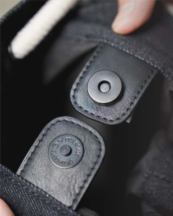 Interior magnetic snap button closure and lining detail on the Light of Dawn Sake Bag in Black Denim at Grandmama Store in Hong Kong.