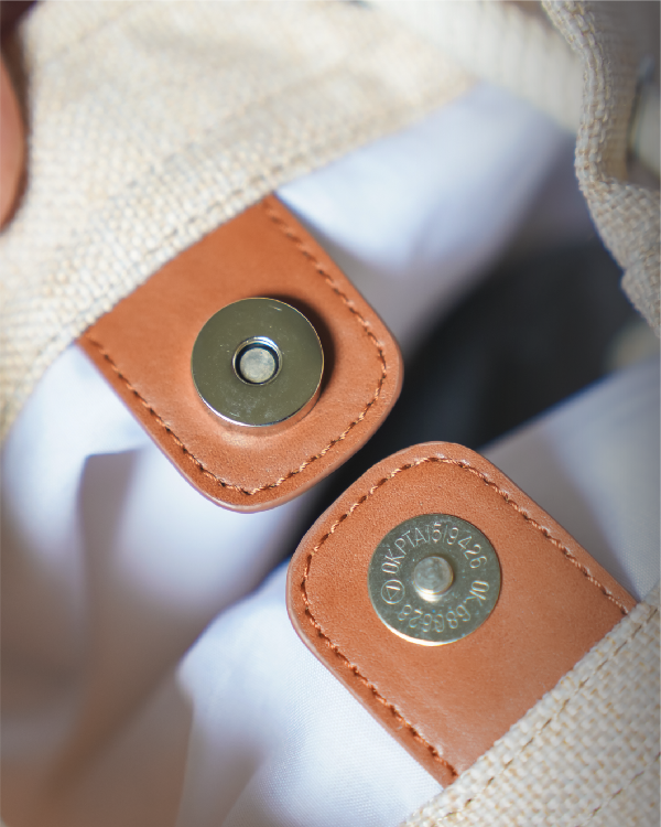 Interior magnetic snap button closure detail on the Light of Dawn Sake Bag in Linen at Grandmama Store in Hong Kong.