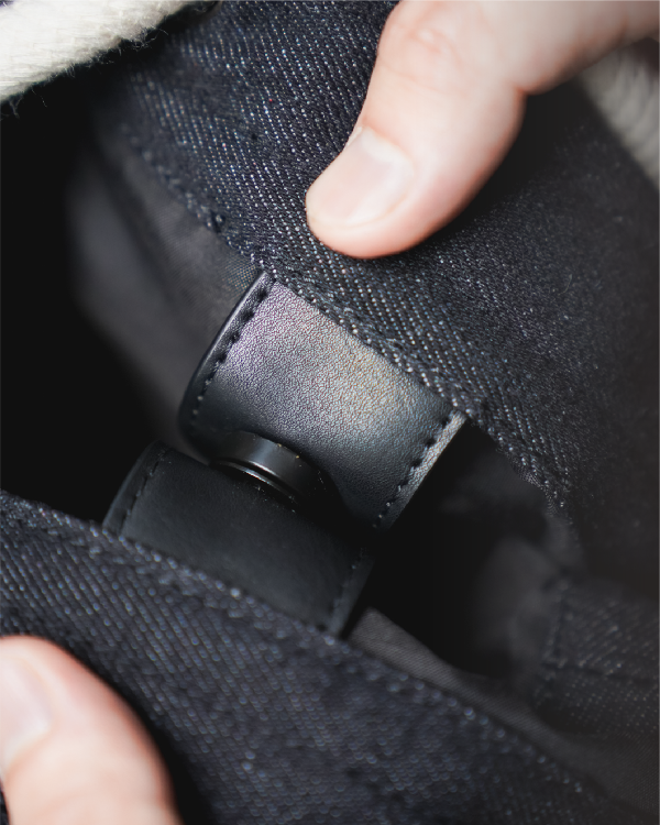 Interior magnetic snap button closure on the Light of Dawn Sake Bag in Black Denim at Grandmama Store in Hong Kong.