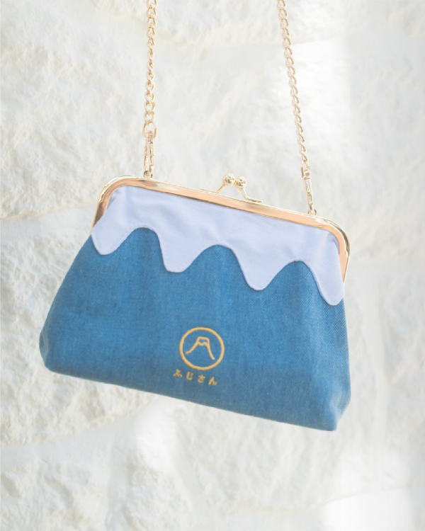 Light blue Mt. Fuji Pocket Bag hanging by its gold chain strap at Grandmama Store in Hong Kong.