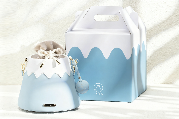 Light sky blue Mt. Fuji Goen Bag next to its custom gift packaging box at Grandmama Store in Hong Kong.
