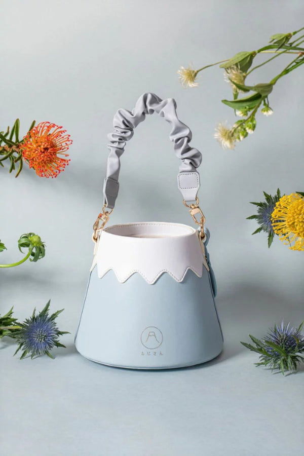 Light sky blue Mt. Fuji Goen Bag styled with scrunchie strap and vibrant flowers at Grandmama Store in Hong Kong.