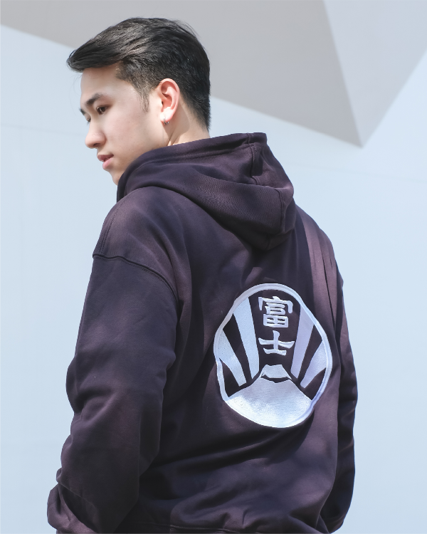 Male model showcasing the back Fujisan embroidered design on a dark purple Kamon Hoodie at Grandmama Store in Hong Kong.