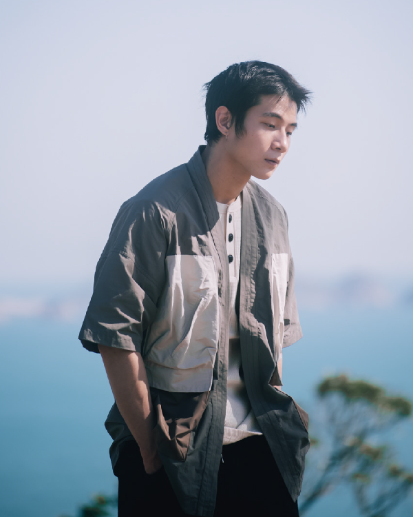 Male model wearing greyish Morikawa Yama Kimono Jacket by the sea at Grandmama Store in Hong Kong.