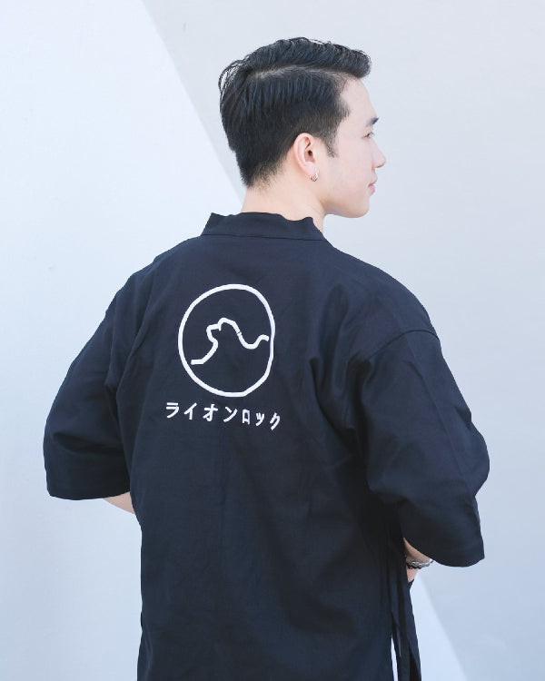 Male model wearing navy blue Kamon Kimono Jacket with Lion Rock embroidery at Grandmama Store in Hong Kong.