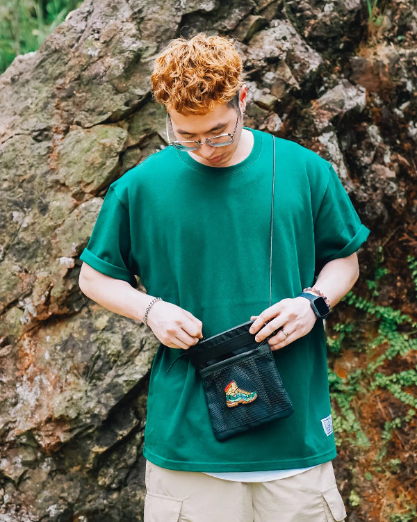 Man wearing black Yama Multifunctional Bag outdoors at Grandmama Store in Hong Kong.