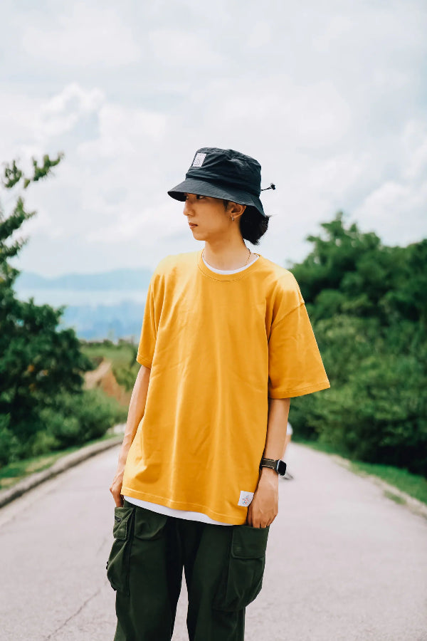 Man wearing the black Yama Workwear Bucket Hat outdoors at Grandmama Store in Hong Kong.