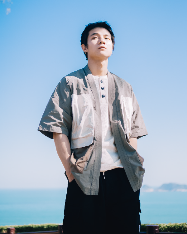 Man wearing the greyish Morikawa Yama Kimono Jacket outdoors at Grandmama Store in Hong Kong.