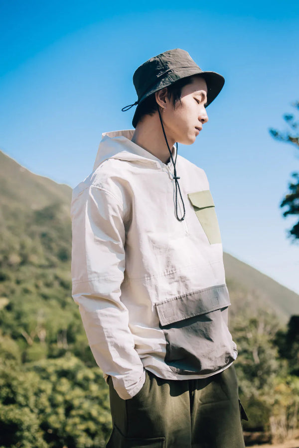 Man wearing the olive green Yama Workwear Bucket Hat outdoors at Grandmama Store in Hong Kong.