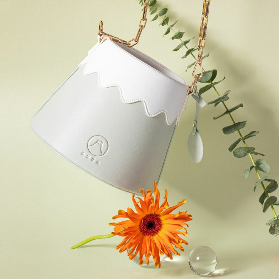 Mint green Mt. Fuji Goen Bag in Forest colourway styled with gerbera daisy and eucalyptus at Grandmama Store in Hong Kong.