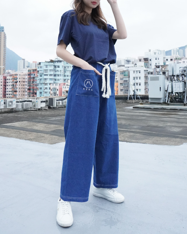 Model posing in blue Japanese waist rope pants on a rooftop at Grandmama Store in Hong Kong.