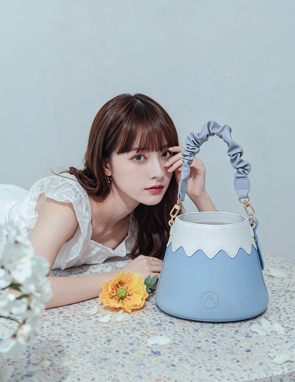 Model posing with the light sky blue Mt. Fuji Goen Bag with scrunchie strap at Grandmama Store in Hong Kong.