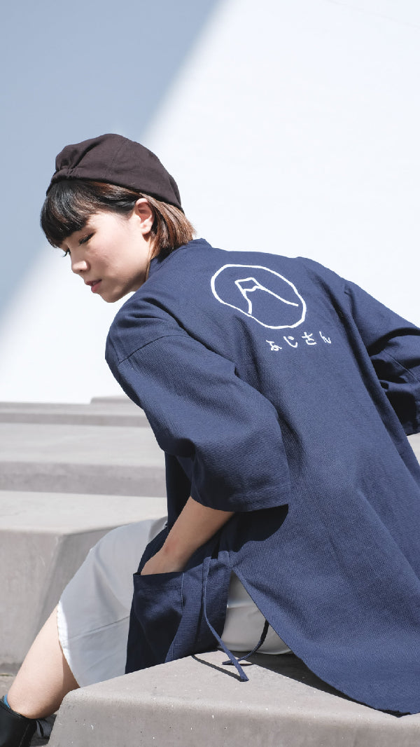 Model wearing a navy blue Kamon Kimono Jacket featuring the Fuji San embroidery design at Grandmama Store in Hong Kong.