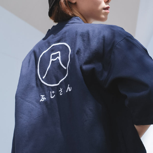 Model wearing a navy blue Kamon Kimono Jacket with a Mount Fuji embroidery design on the back at Grandmama Store in Hong Kong.