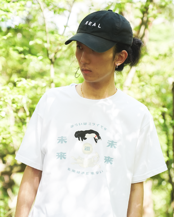 Model wearing the white Lazy Cat Tee outdoors at Grandmama Store in Hong Kong.