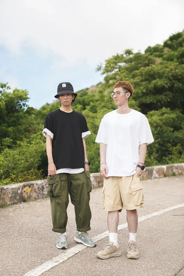 Models wearing black and white Yama Basic Color Tees in an outdoor setting at Grandmama Store in Hong Kong.