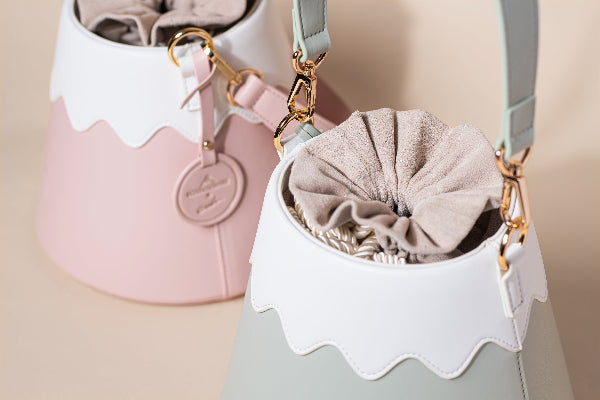 Pastel pink and sage green Mt. Fuji Goen Bags showing drawstring pouches and gold hardware at Grandmama Store in Hong Kong.