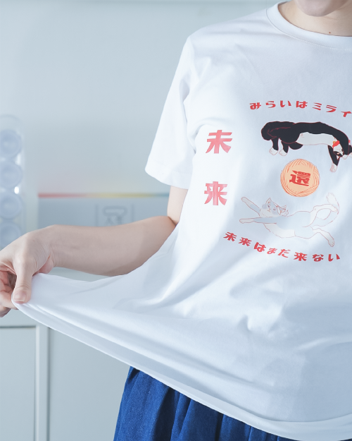 Person demonstrating fabric stretch on the white Lazy Cat Tee at Grandmama Store in Hong Kong.