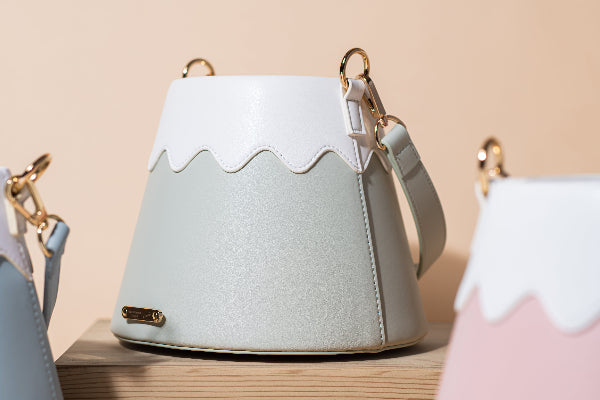 Shimmering sage green Mt. Fuji Goen Bag displayed with other pastel colorways at Grandmama Store in Hong Kong.